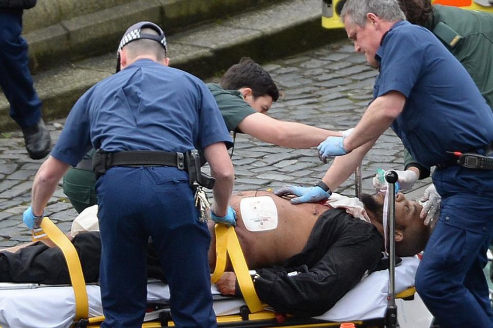 A man believed to be Westminster attacker Khalid Masood is treated by medics (Stefan Rousseau/PA )