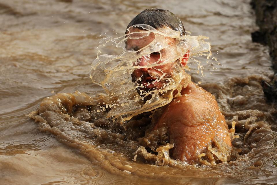 A competitor shakes water off his head during the Tough Guy event in Perton, central England