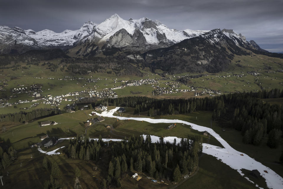 FILE - An artificial snow slope created for skiers in Wildhaus, Switzerland, Wednesday, Jan. 4, 2023. The Swiss alps are confronted with a lack of snow and warm temperatures. (Gian Ehrenzeller/Keystone via AP, File)
