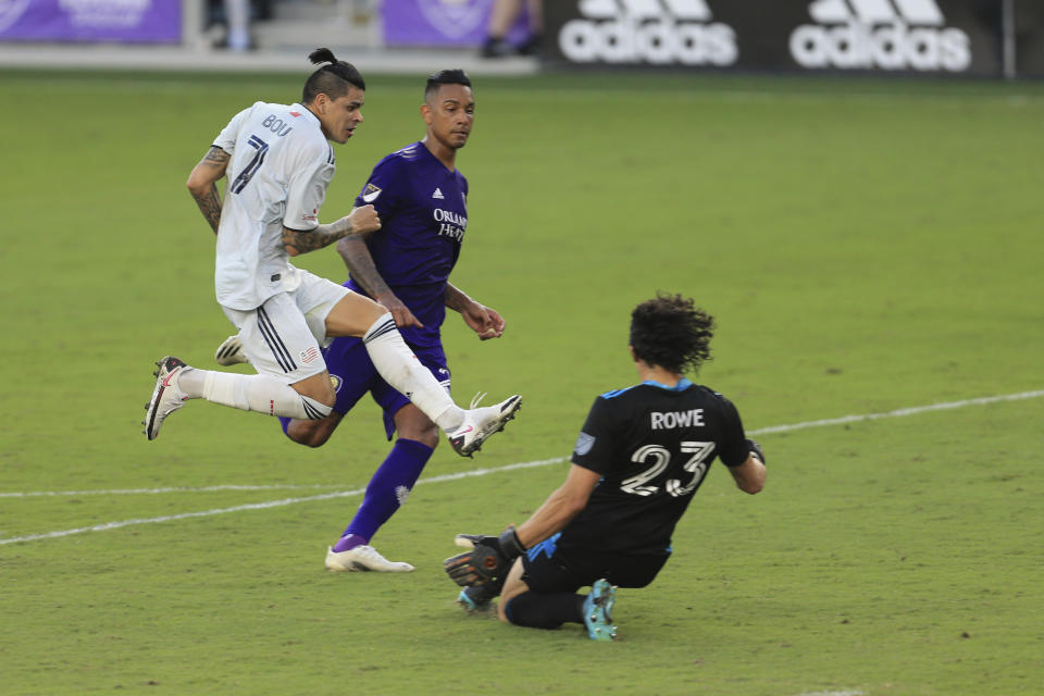 New England Revolution forward Gustavo Bou (7) scores a goal past Orlando City goalkeeper Brian Rowe (23) and defender Antonio Carlos (25) during the second half of an MLS playoff soccer match, Sunday, Nov. 29, 2020, in Orlando, Fla. (AP Photo/Matt Stamey)