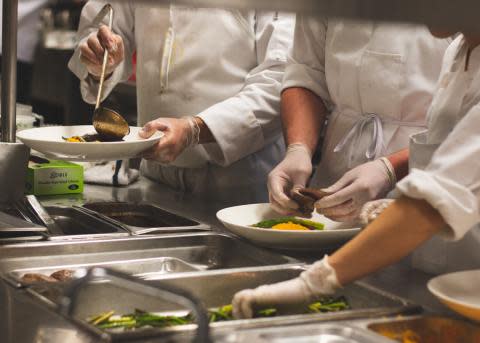 Florida State students in the Dedman College of Hospitality preparing one of the fourse course meals in the Little Dinner Series.