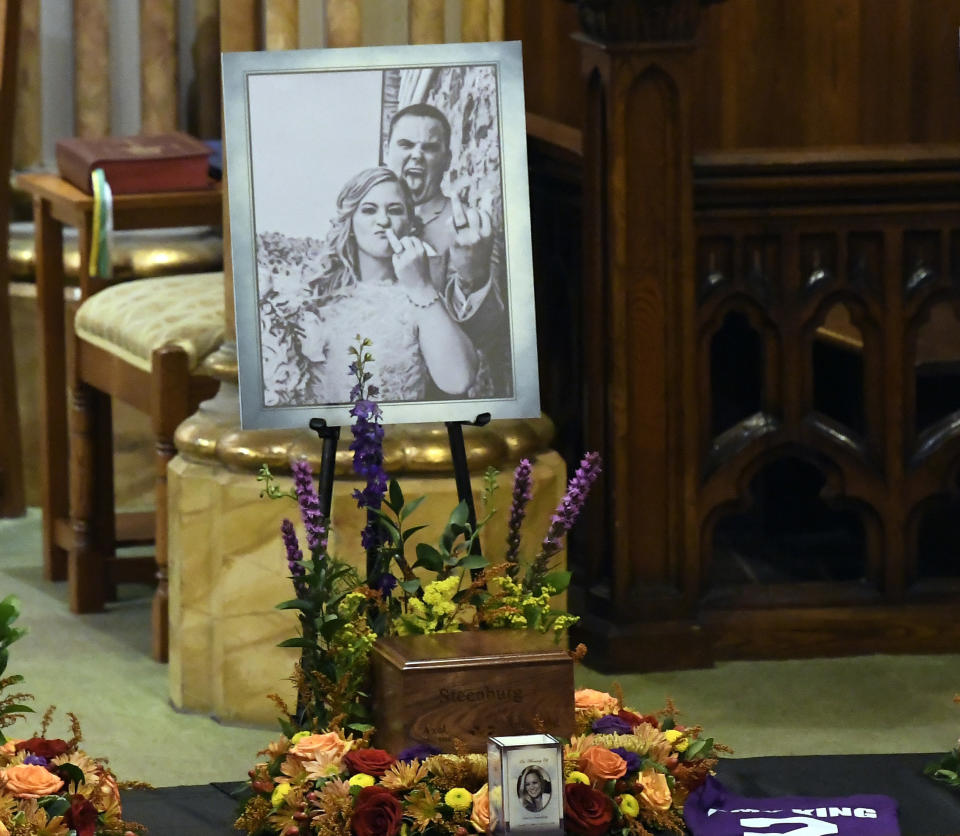 CORRECTS TO AMY STEENBURG'S ASHES, AND NOT THE COMBINED ASHES OF AMY AND AXEL STEENBURG. ALSO CORRECTS SPELLING OF LAST NAME. - A picture of Axel Steenburg and Amy Steenburg is displayed near an urn with Amy's ashes at St. Stanislaus Roman Catholic Church in Amsterdam, N.Y., on Saturday, Oct. 13, 2018, as friends and family prepare for a funeral mass for eight of the 20 people killed in a fatal limousine crash a week earlier in Schoharie, N.Y. (AP Photo/Hans Pennink)