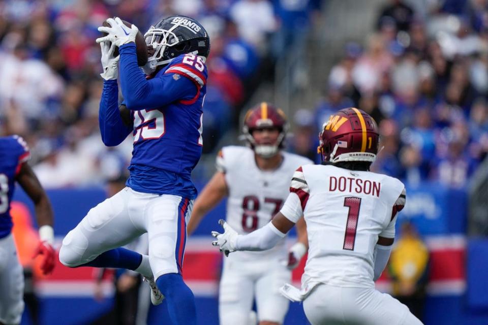 New York Giants cornerback Deonte Banks (25) catches an interception during the first half an NFL football game against the Washington Commanders, Sunday Oct. 22, 2023, in East Rutherford, N.J. (AP Photo/Bryan Woolston)