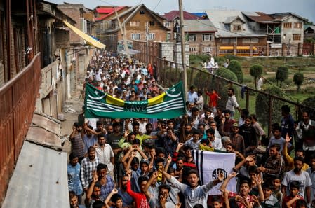 FILE PHOTO: Kashmiri men shout slogans during a protest after the scrapping of the special constitutional status for Kashmir by the Indian government, in Srinagar