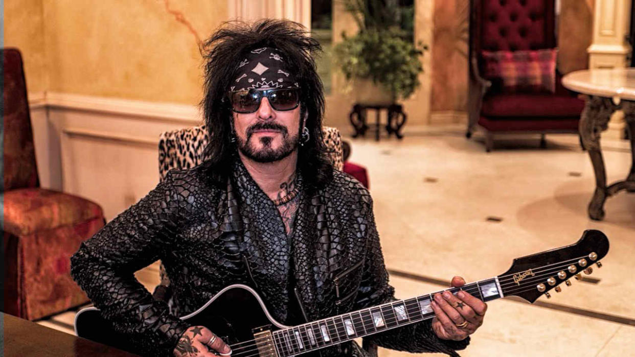  Nikki Sixx playing a guitar 