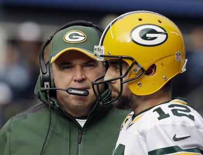 FILE - In this Jan. 18, 2015, file photo Green Bay Packers head coach Mike McCarthy talks to quarterback Aaron Rodgers (12) during the first half of the NFL football NFC Championship game against the Seattle Seahawks in Seattle. Admitting that he is &quot;going to miss it,&quot; Packers coach McCarthy said Thursday, Feb. 12, 2015, that he will give up his job calling plays for Aaron Rodgers and the rest of the Green Bay offense. McCarthy is handing off play-calling duties to Tom Clements, whom he promoted from offensive coordinator to associate head coach. (AP Photo/David J. Phillip, File)