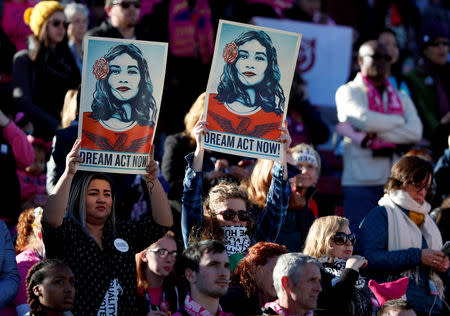 FILE PHOTO: Supporters of Deferred Action for Childhood Arrivals (DACA) hold signs during the Women's March rally in Las Vegas, Nevada, U.S. January 21, 2018. REUTERS/Steve Marcus/File Photo
