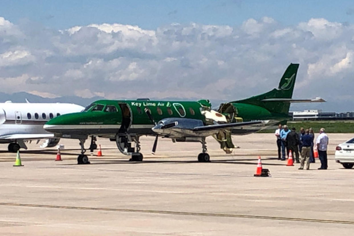 This image from CBS Denver shows a Key Lime Air Metroliner that landed safely at Centennial Airport after a mid-air collision near Denver on Wednesday, May 12, 2021. Federal officials say two airplanes collided but that there are no injuries. The collision between a twin-engine Fairchild Metroliner and a single-engine Cirrus SR22 happened as both planes were landing, according to the National Transportation Safety Board. Key Lime Air, which owns the Metroliner, says its aircraft sustained substantial damage to the tail section but that the pilot was able to land safely. (CBS Denver via AP)