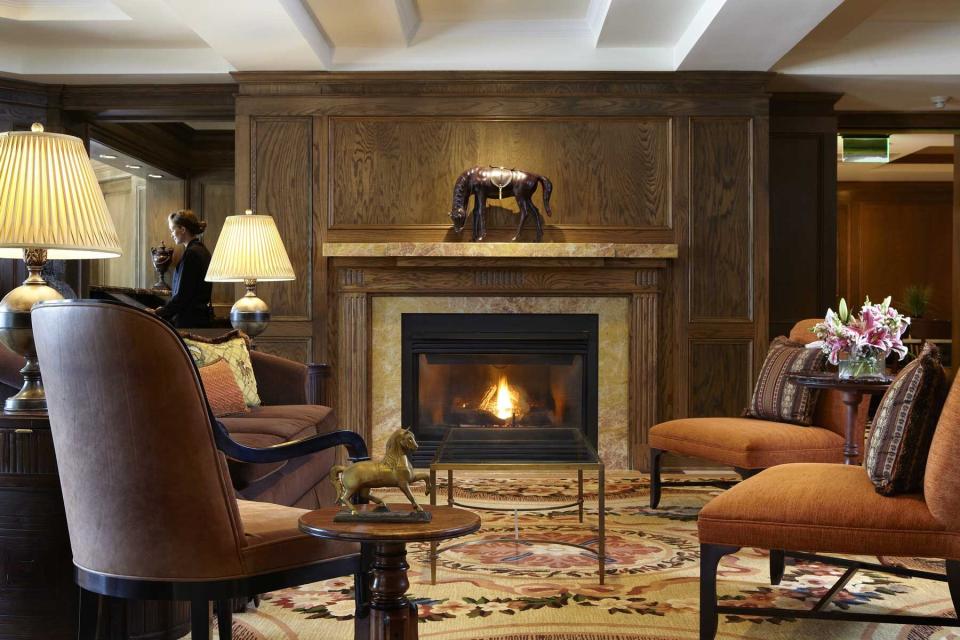 The Lincoln Room, featuring a fireplace, at the American Club at Destination Kohler