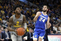 Marquette's Sacar Anim (2) drives to the basket against Creighton's Mitch Ballock (24) during the first half of an NCAA college basketball game Tuesday, Feb. 18, 2020, in Milwaukee. (AP Photo/Aaron Gash)