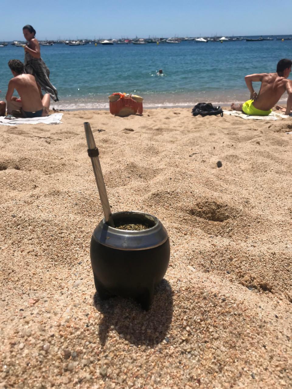 cup of yerba mate on the beach
