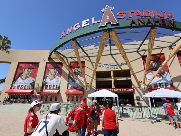 Anaheim, CA - July 21: Angels starting pitcher, two-way player and designated hitter Shohei Ohtani's image (at left) looms large over fans waiting to get in to see the Angels play the Pirates at Angel Stadium in Anaheim Friday, July 21, 2023. (Allen J. Schaben / Los Angeles Times)