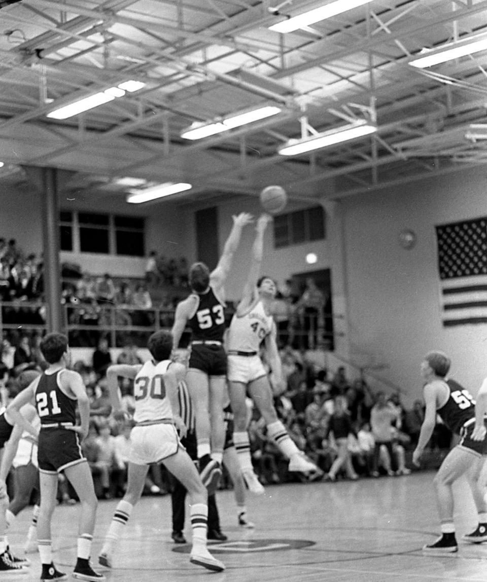 Chillicothe's Greg Jurcisin (40) takes the jump from Newark's Dennis Odle at the start of the fourth quarter. In the picture are Newark's John Snow (21), Chillicothe's Jim Johnson (30) and Newark's Brice Kibler (55). The Newark Wildcats came from behind to beat the Chillicothe Cavaliers 47-46 at Hatton Memorial Gym on Jan. 24, 1969.