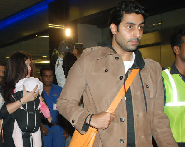 Papa Abhishek walks in the front while Ash follows with the baby