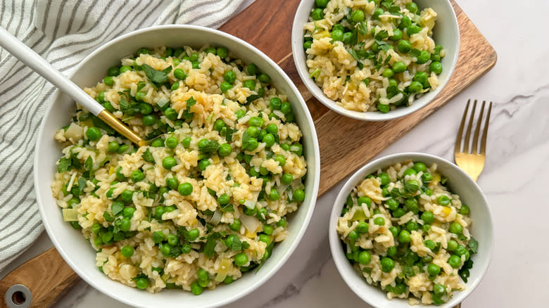 risi e bisi rice and peas in white bowls