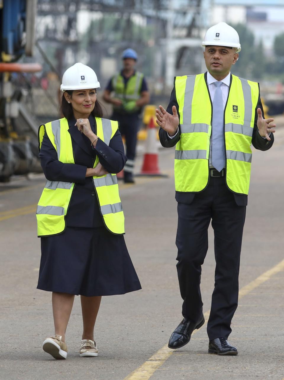 Britain's Chancellor of the Exchequer Sajid Javid, right, and Home Secretary Priti Patel visit Tlbury Docks, south east London, Thursday Aug. 1, 2019. (Alex Lentati/Pool via AP)
