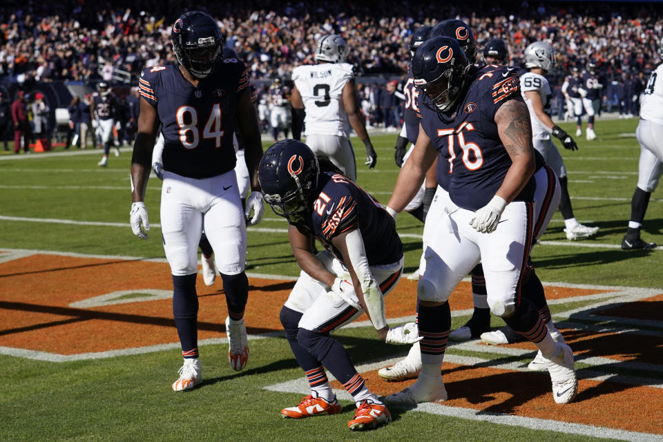 Chicago Bears running back D'Onta Foreman (21) celebrates after scoring his second touchdown against the Las Vegas Raiders in the first half of an NFL football game Sunday, Oct. 22, 2023, in Chicago. (AP Photo/Charles Rex Arbogast)