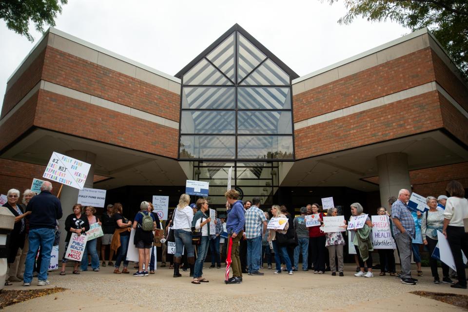 Ottawa County residents gather outside the Fillmore Complex in September 2023 to protest the county budget.