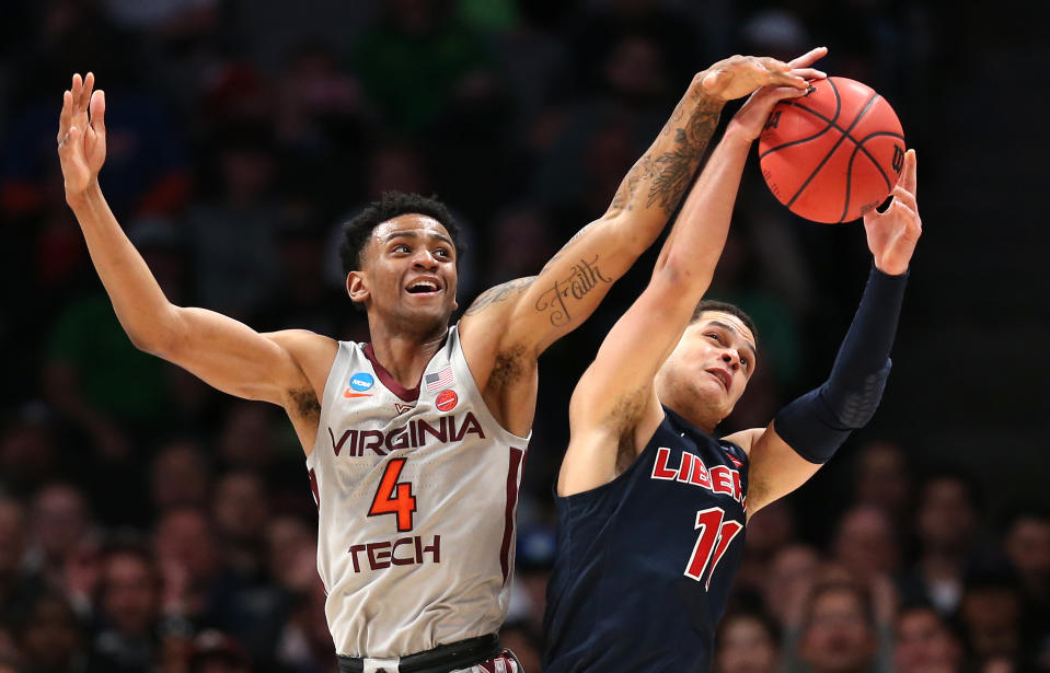 <p>Nickeil Alexander-Walker #4 of the Virginia Tech Hokies competes for the ball wtih Georgie Pacheco-Ortiz #11 of the Liberty Flames in the second half during the second round of the 2019 NCAA Men’s Basketball Tournament at SAP Center on March 24, 2019 in San Jose, California. (Photo by Ezra Shaw/Getty Images) </p>