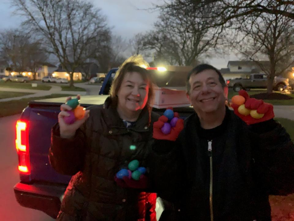 Friends of John Glenn Music advisors and volunteers Kathy and Tom Russell distribute candy-filled eggs for the organization's 2023 Egg My Yard Easter fundraiser.