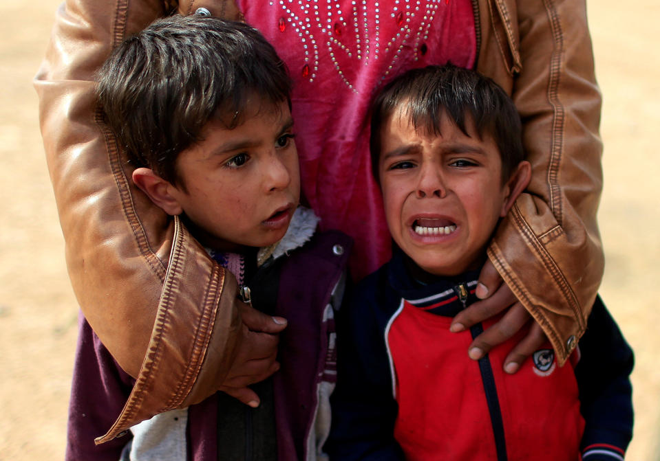 Displaced Iraqi boys cry after their father was killed in Mosul