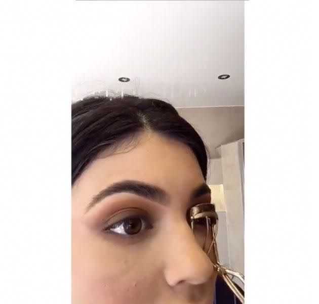 Kylie curling her eyelashes. Source: Snapchat