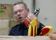 U.S. Customs and Border Protection field operations director Todd Owen displays counterfeit Louboutin pumps and high heels featuring the distinctive red sole of French designer Christian Louboutin are displayed at Price Transfer Warehouse on August 16, 2012 in Long Beach, California.