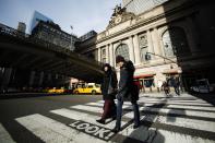 People walk in front of the entrance of Grand Central Station in New York, February 2, 2013. Grand Central Terminal, the doyenne of American train stations, is celebrating its 100th birthday. Opened on February 2, 1913, the iconic New York landmark with its Beaux-Arts facade is an architectural gem, and still one of America's greatest transportation hubs. (REUTERS/Eduardo Munoz)