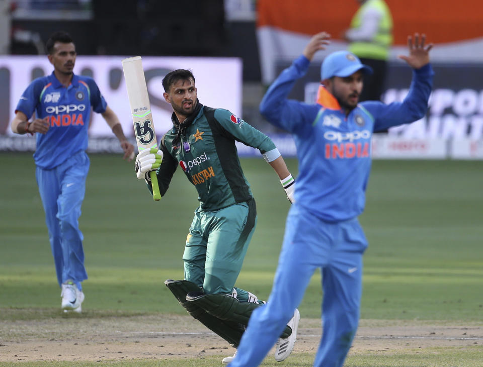 Pakistan's Shoaib Malik, center, after India's Bhuvneshwar Kumar dropped his catch during the one day international cricket match of Asia Cup between India and Pakistan in Dubai, United Arab Emirates, Wednesday, Sept. 19, 2018. (AP Photo/Aijaz Rahi)