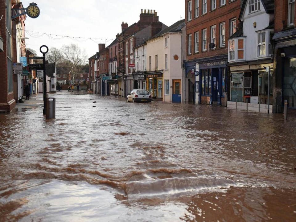 Teme Street in Tenbury Wells, a market town in Worcestershire, is seen under floodwater from the overflowing River Teme amid Storm Dennis ( AFP via Getty Images )
