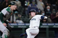 Seattle Mariners' Jarred Kelenic, right, begins his slide home to score as Oakland Athletics catcher Sean Murphy waits for the ball in the fourth inning of a baseball game Monday, Sept. 27, 2021, in Seattle. (AP Photo/Elaine Thompson)