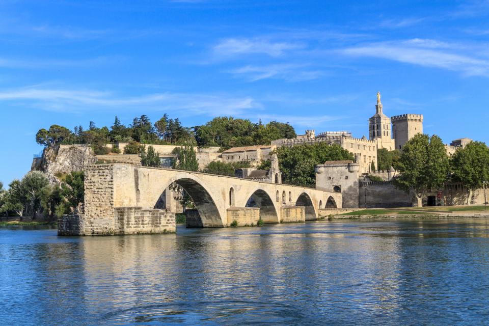 The famous bridge at Avignon, with the fortress Palace of the Popes in the background.