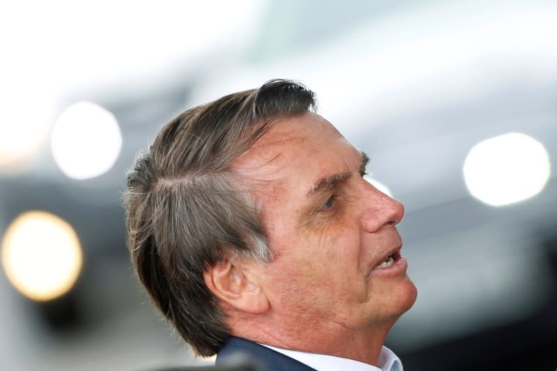 Brazil's President Jair Bolsonaro looks on as he leaves the Alvorada Palace in Brasilia