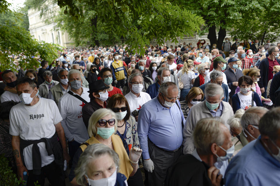 People attend an anti-Nazi protest outside the Sacred Heart Cathedral during a mass commemorating members of the pro-Nazi Croatian WWII Ustasha regime, responsible for sending tens of thousands of Serbs, Gypsies and Jews to their death in concentration camps, who were killed at the end of WWII by Yugoslav communist troops, in Sarajevo, Bosnia, Saturday, May 16, 2020. Bosnian Catholic clerics along with Croatian state representatives and members of the Bosnian Croats community attended a religious service commemorating the massacre of Croatian pro-Nazis by victorious communists at the end of World War II. (AP Photo/Kemal Softic)