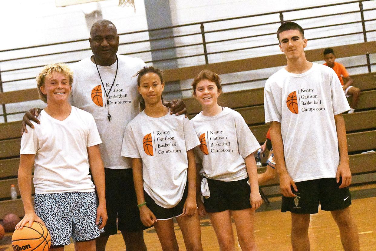 Former NBA player Kenny Gattison poses for a photo with Braylon Beam, Phoebe Asoegwu, Sophia Lewis and Felix Kay during a basketball camp Tuesday June 27, 2023 at Roland Grise Middle School in Wilmington N.C.  KEN BLEVINS/STARNEWS