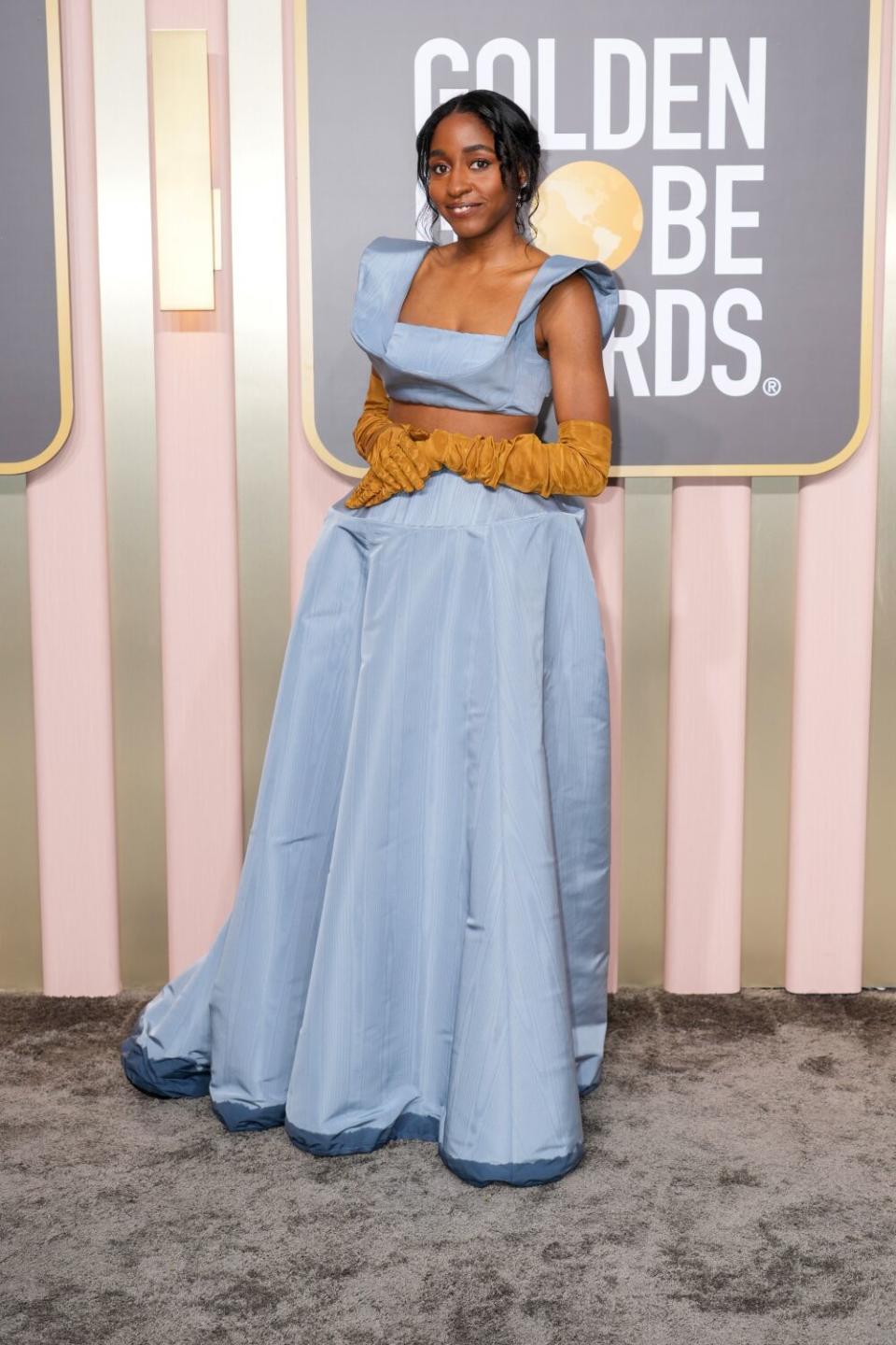 Ayo Edebiri poses in a Rosie Assoulin gown on the red carpet.