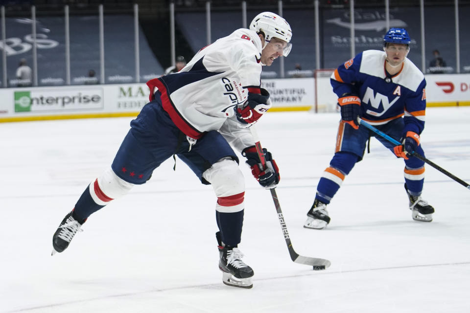 Washington Capitals' Evgeny Kuznetsov (92) shoots the puck past New York Islanders' Josh Bailey (12) for a goal during the third period of an NHL hockey game Saturday, April 24, 2021, in Uniondale, N.Y. The Capitals won 6-3. (AP Photo/Frank Franklin II)