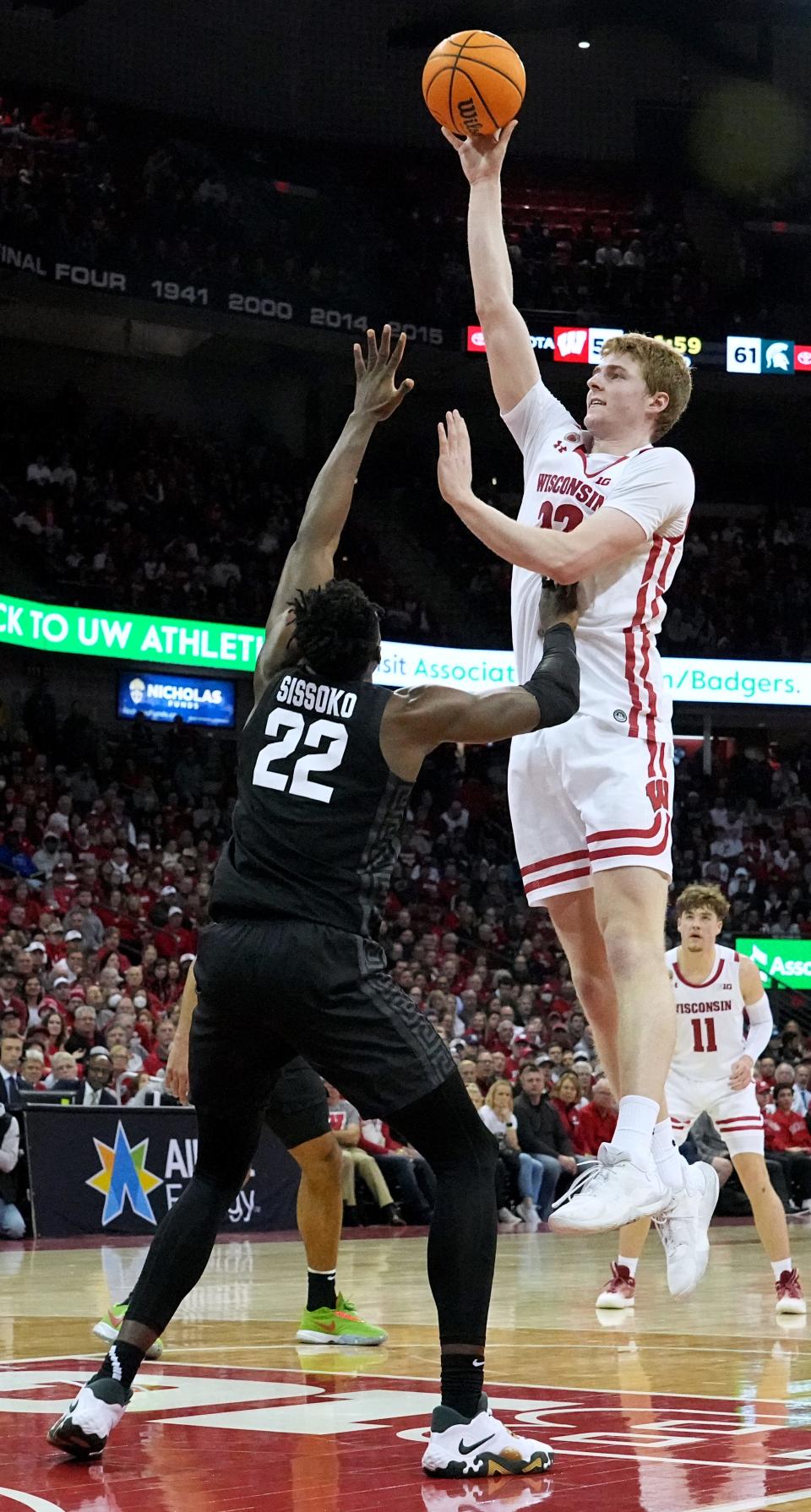 Wisconsin forward Steven Crowl (22) scores on Michigan State center Mady Sissoko (22) during the second half of their game Tuesday, January 10, 2023 at the Kohl Center in Madison, Wis. Michigan State beat Wisconsin 69-65.