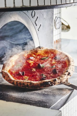 <p>COURTESY OF VITTORIA PIZZA</p> A bubbly Neapolitan-style tomato pie from Pizzeria Vittoria
