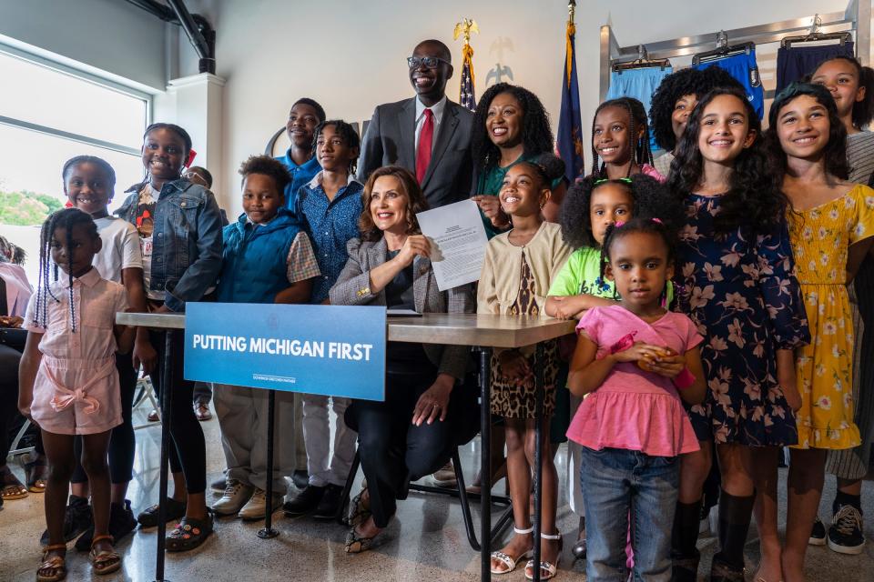 Michigan Governor Gretchen Whitmer poses for a photo with children after signing the CROWN Act prohibiting race-based hair discrimination on Thursday, June 15, 2023, at Moneyball Sportswear in Lansing. The law  ensures that no one can be denied employment or educational opportunities because of hair texture or protective styles. Michigan will be the 23rd state to sign the CROWN Act into law. 