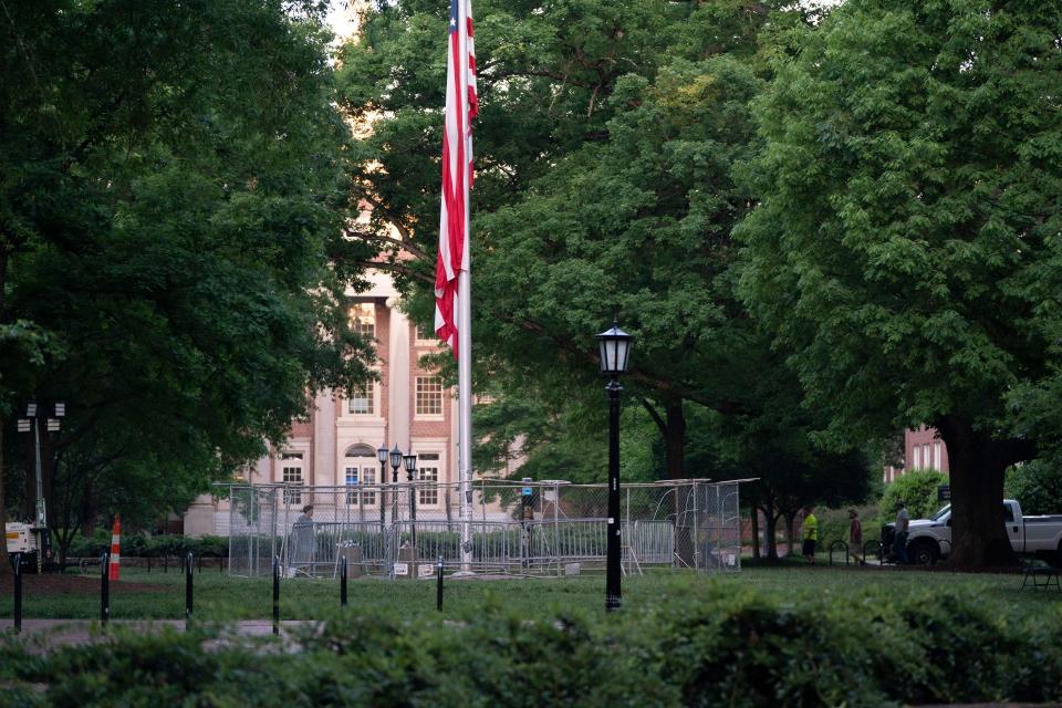 The American flag is surrounded by a temporary barrier at Polk Place at the University of North Carolina at Chapel Hill on May 1, 2024. The day before, protesters removed the American flag and raised the Palestinian flag following arrests and the breaking up of an encampment on campus.