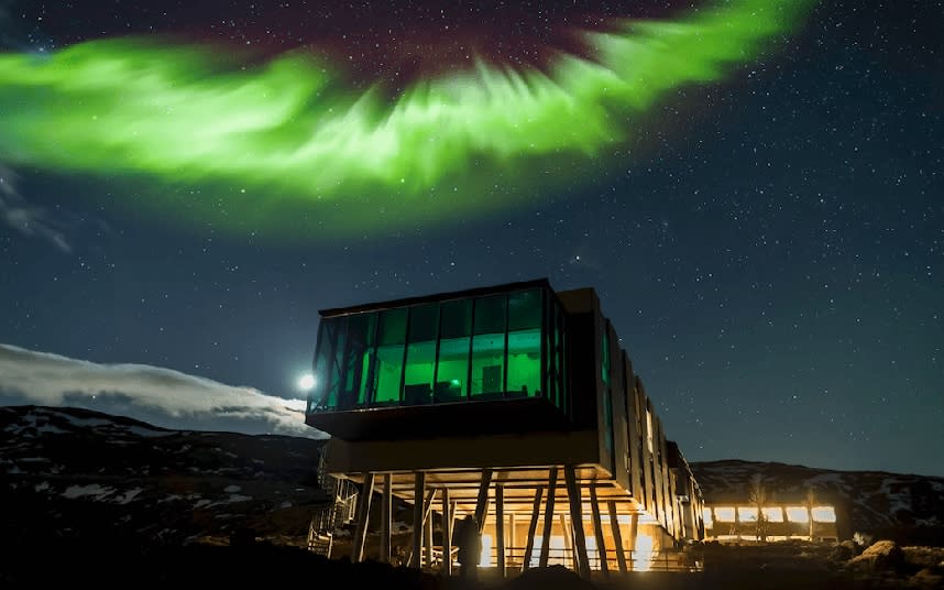 The glass-walled bar at ION Luxury Adventure Hotel in Iceland makes a cosy spot from which to view the elusive Northern Lights