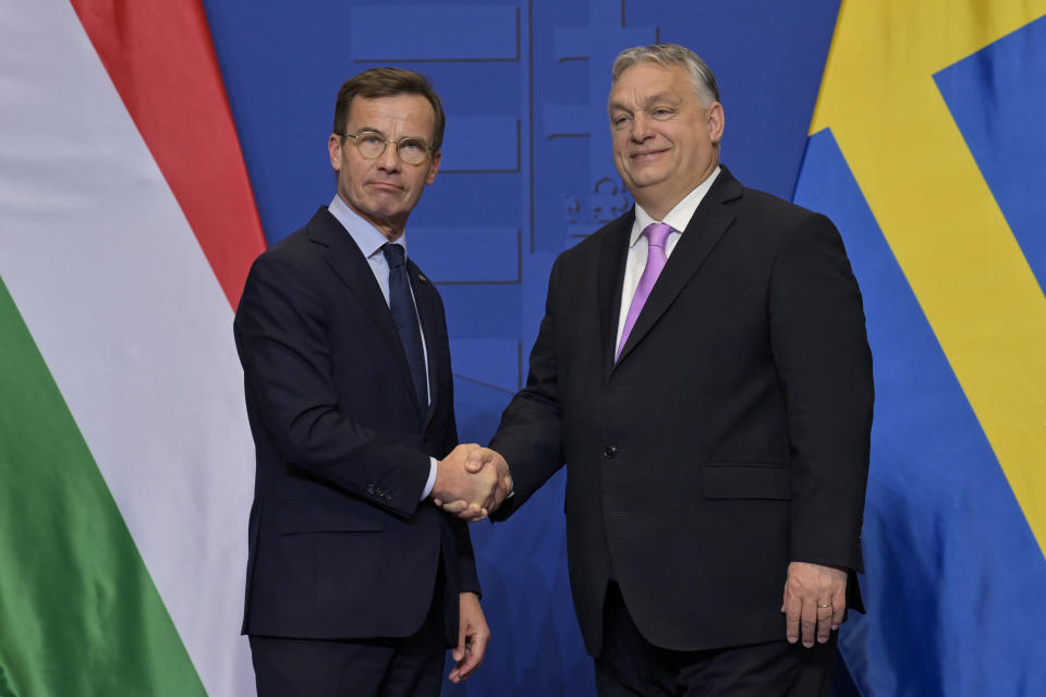 Sweden's Prime Minister Ulf Kristersson, left, shakes hands with his Hungarian counterpart Viktor Orban at the Carmelite Monastery in Budapest, Hungary, Friday, Feb 23, 2024. Nearly two years after Sweden formally applied to join NATO, its membership now hinges on convincing one country - Viktor Orban's Hungary - to formally ratify its bid to join the military alliance. (AP Photo/Denes Erdos)