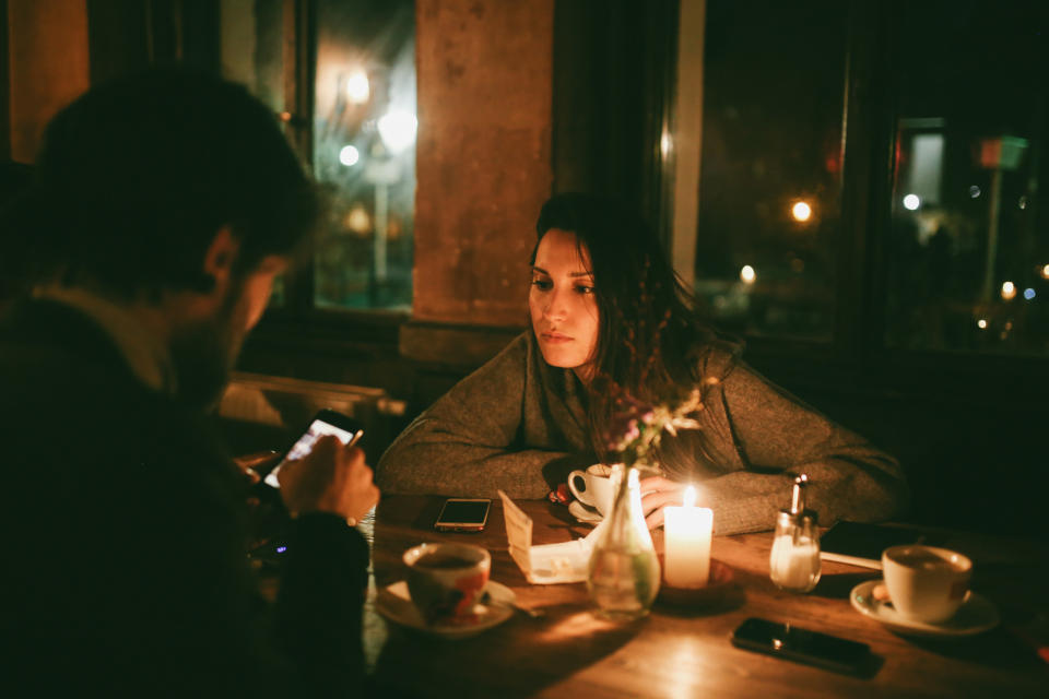 a restaurant table only lit up by a candle