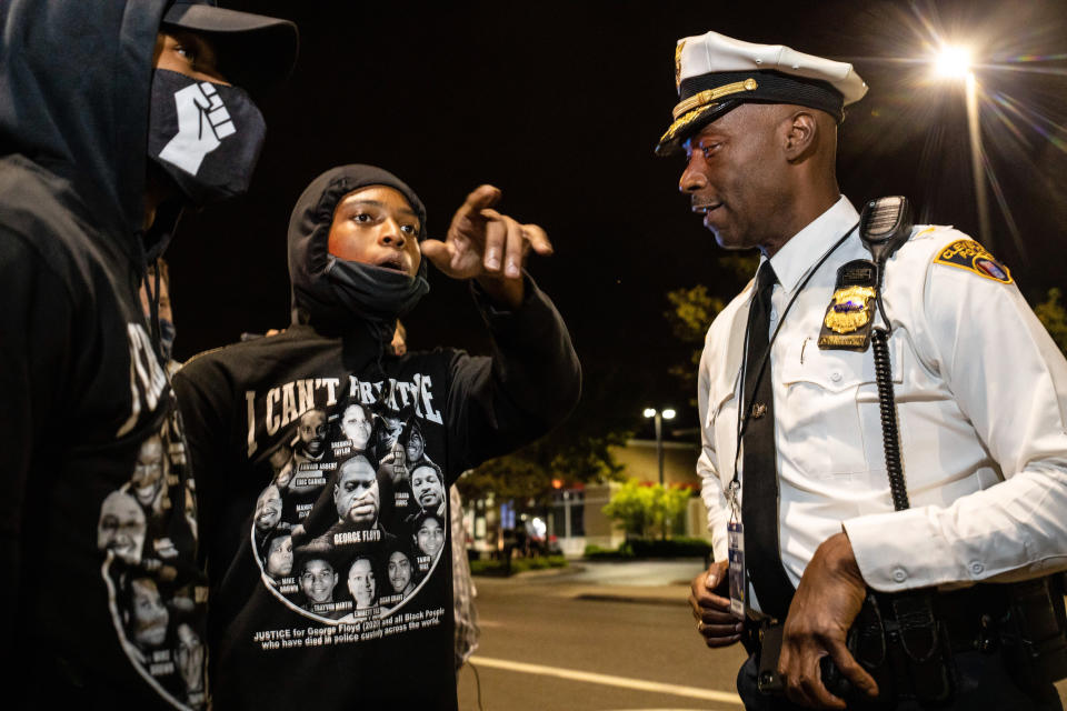 A police officer talks with protesters in front of the police barricade during the protest. (Stephen Zenner/SOPA Images/LightRocket via Getty Images)