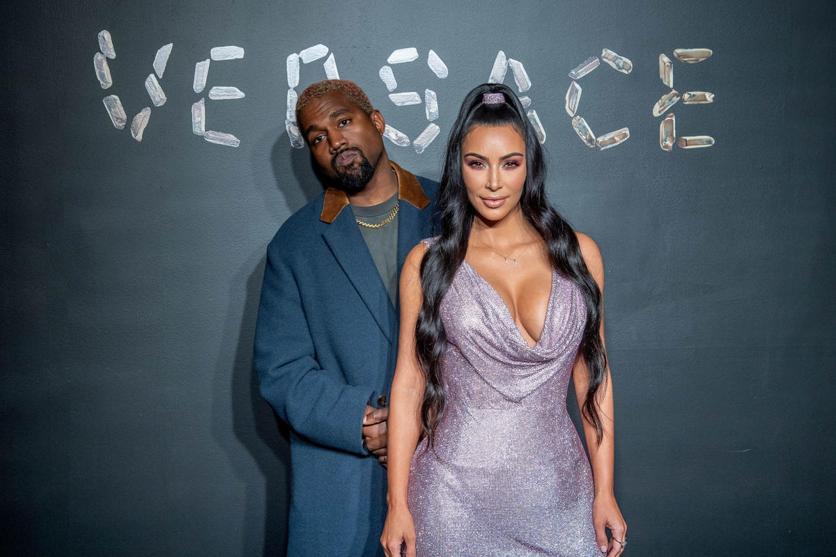 Kim Kardashian poses with Kanye West and artist Takashi Murakami in Tokyo