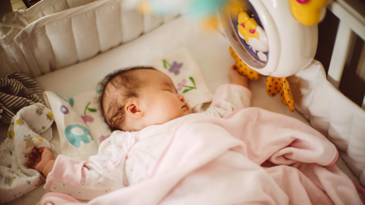 Adorable baby girl sleeping soundly in the crib