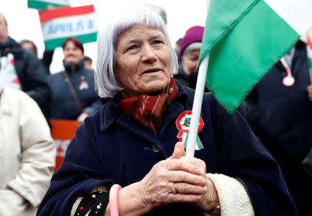 A woman attends Hungarian march at a pro-Orban rally during Hungary's National Day celebrations, which also commemorates the 1848 Hungarian Revolution against the Habsburg monarchy, in Budapest, Hungary March 15, 2018. Picture taken March 15, 2018. REUTERS/Bernadett Szabo