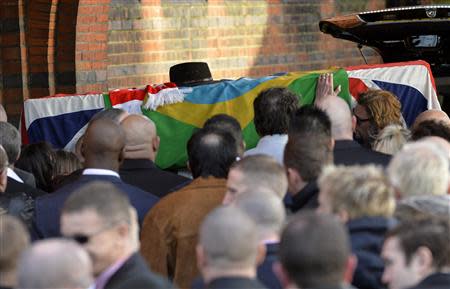 The coffin of Ronnie Biggs is carried into Golders Green Crematorium in north London January 3, 2014. REUTERS/Toby Melville