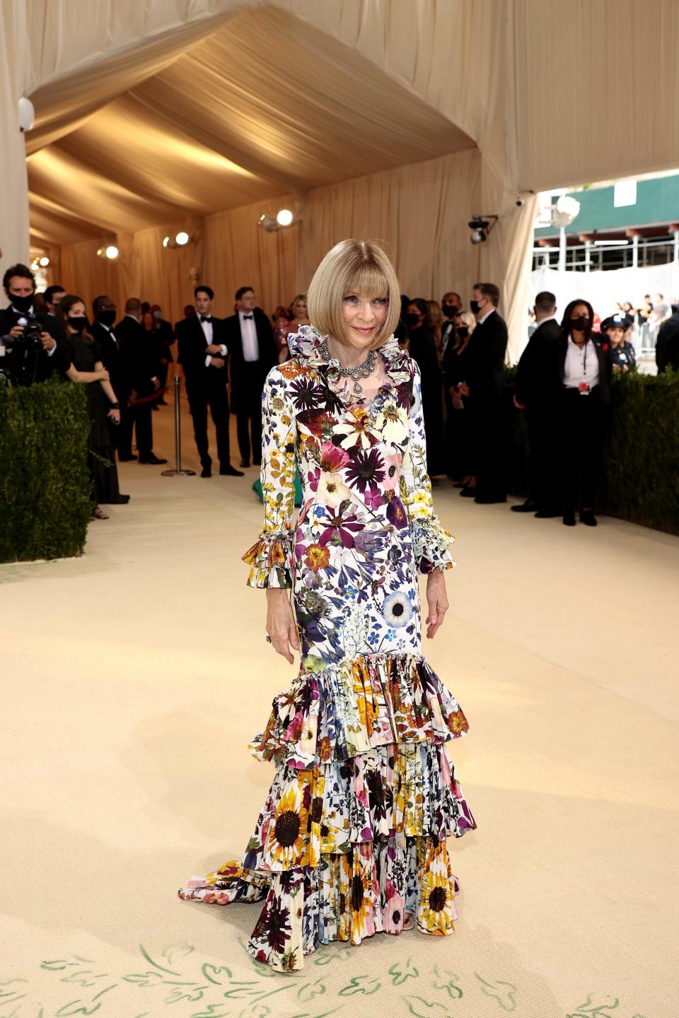 Anna Wintour wears a floral dress on the 2021 Met Gala red carpet.